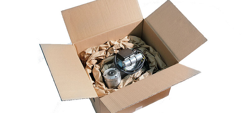 
		  A cardboard box containing a technical device and paper cushioning