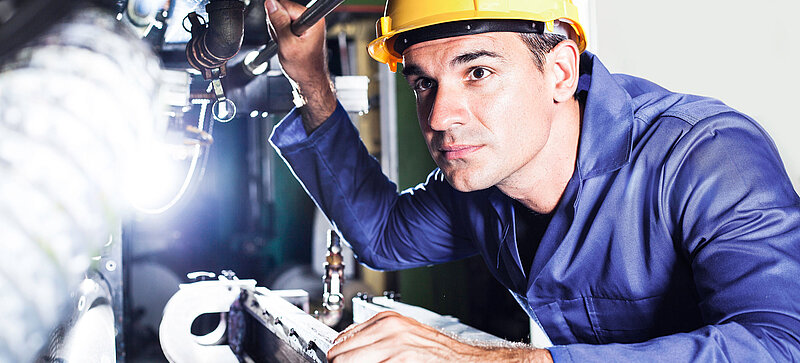 
		  A man working at a machine