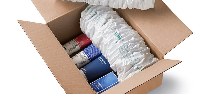 
		  A cardboard box containing cosmetics and white paper cushioning
